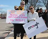 Two people carrying placards