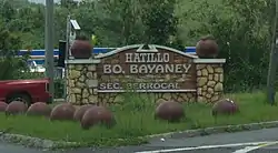 Rock wall at entrance to Bayaney