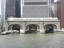 The Battery Maritime Building as seen from the East River, with buildings behind it