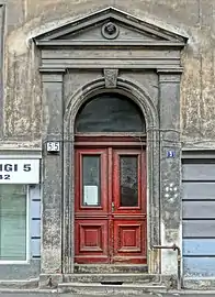 Entrance portal capped by a medallion