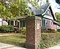 389 Norton Parkway at Goffe Terrace (1908), gate cottage with pier and tile beaver plaque.