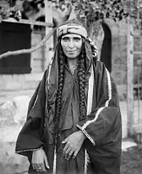 Image 1A Bedouin woman in Jerusalem, sometime between 1898 and 1914, dressed in Palestinian costume, the traditional clothing worn by Palestinians. Many of the handcrafted garments were richly embroidered and the creation and maintenance of these items played a significant role in the lives of the region's women. Until the 1940s, traditional Palestinian costumes reflected a woman's economic status, whether married or single, and the town or district of origin, and a knowledgeable observer could glean such information from the fabric, colors, cut, and embroidery motifs (or lack thereof) in a given woman's apparel.