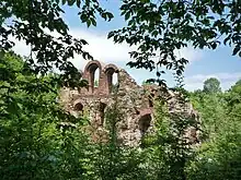 An ancient brick wall with a number of wide arches