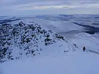 A walker descending by the tourist route, seen from the summit in January 2010.