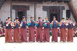 Girls in national dress dancing during the annual Gangteng tshechu in Phobjikha Valley