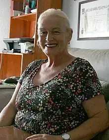 A photograph of Bibiana Montoya smiling and sitting down while wearing a floral top