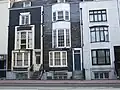 Black mathematical tiles on houses with unusual offset bay windows on Grand Parade Location on Google Maps