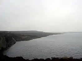 A lake with a rocky shoreline