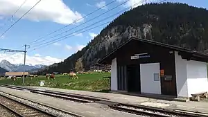 Shelter next to double-track railway line with mountain behind