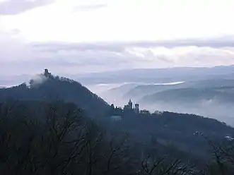 Dawn view from Petersberg into Rhine valley, showing the castle ruins on the Drachenfels and the Schloss Drachenburg