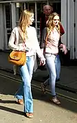 Image 64Two women wearing flared trousers, jeggings and oversized cardigans (from 2010s in fashion)