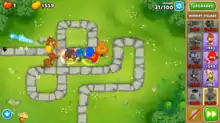 An in-game screenshot of several  different monkeys attacking the Bloons and supporting each other.