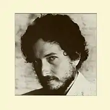 A black-and-white photograph of Bob Dylan