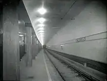 A black-and-white photo of an underground streetcar station