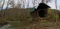 Damaged bridge on the riverbank after Hurricane Irene in 2011