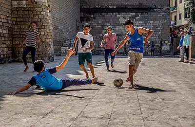 Boys playing street football in Egypt