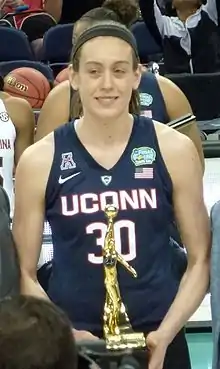 Breanna Stewart holding a gold-plated trophy in both hands in 2016