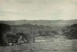 A valley with a barn and pastures