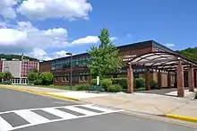 Two-floor brick building façade, entranceway, and round theater