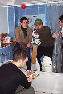 Brigadier Ambrose playing cricket in the bathroom