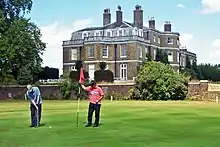 Side elevation of Briggens house with golf course