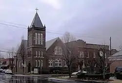 Large building complex with belltower and sanctuary.