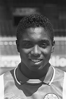 Black and white portrait photograph of a 19-year old Bryan Roy in his Ajax jersey