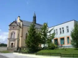 Main street in Bukowsko, Catholic Church and city bank.