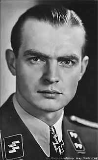 A man wearing a military uniform with an Iron Cross displayed at the front of his uniform collar.