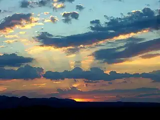 Particles in the atmosphere and the sun's angle enhance colors of stratocumulus cumulogenitus at evening twilight.