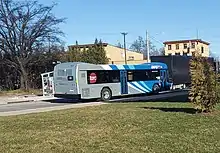 Blue-and-gray bus, seen from behind