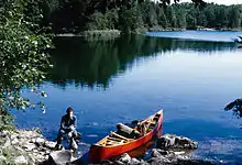 A BWCA paddler with her wood-and-canvas canoe