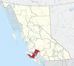 A map of British Columbia depicting its 29 regional districts and equivalent municipalities. One is highlighted in red.