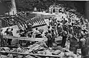 CB 11's Community action dam building project.  Over 200 Samoan women carried concrete to the dam construction site assisting the Seabees to get it done