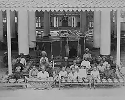 large group of musicians in Javanese costume, with percussion instruments