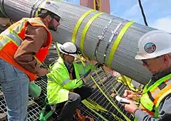 Inspectors verify proper compaction by measuring the cable's circumference.