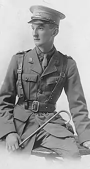 A half-length portrait of a man in military uniform leaning against a table.