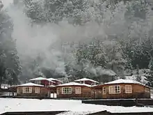 Snow-covered cottages near Curarrehue, Chile