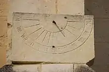 Antique sundial with clumsily engraved numerals