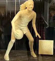 A butter sculpture depicting Clark dribbling a basketball