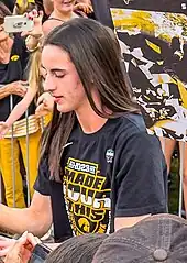 Clark signing an autograph at a team celebration