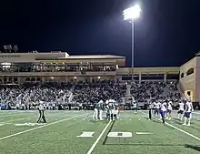 The Cal Poly football team's offense huddles in the red zone during a Big Sky Conference home win over Northern Colorado in 2023.