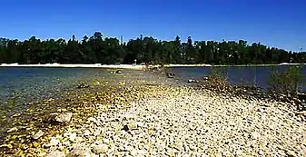 View of the tombolo and island from the mainland on August 18, 2006; during August 2006 Lake Michigan had an average water level of 176.13 meters above sea level.