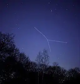 Stars seen at night, with a white line linking the various stars forming the Cancer constellation.