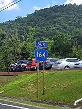 Southbound sign between Achiote and Naranjito barrio-pueblo