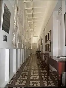 Interior view of a gallery with fixed wood louvers in a "martillo" (ell) extension to the house at Calle Mayor #14 (Casa Paoli)