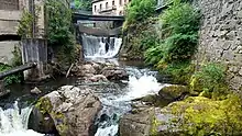 Low-angle shot of the Durolle waterfall as it crosses Thiers at the Creux de l'enfer.