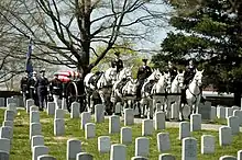 The casket of Caspar Weinberger, 15th United States Secretary of Defense, in a ceremonial funeral procession en route to its final resting place in Arlington National Cemetery on April 4, 2006.