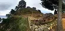 stone walls on a rocky promontory overlooking the sea