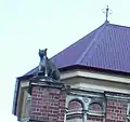 Cat sculpture on the parapet of the Mansions — Margaret Street façade